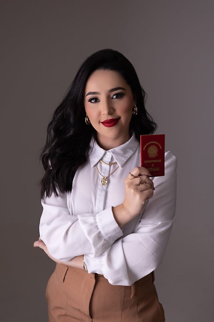 pexels-photo-27987922 Elegant woman with red lipstick holding an international passport in studio setting.